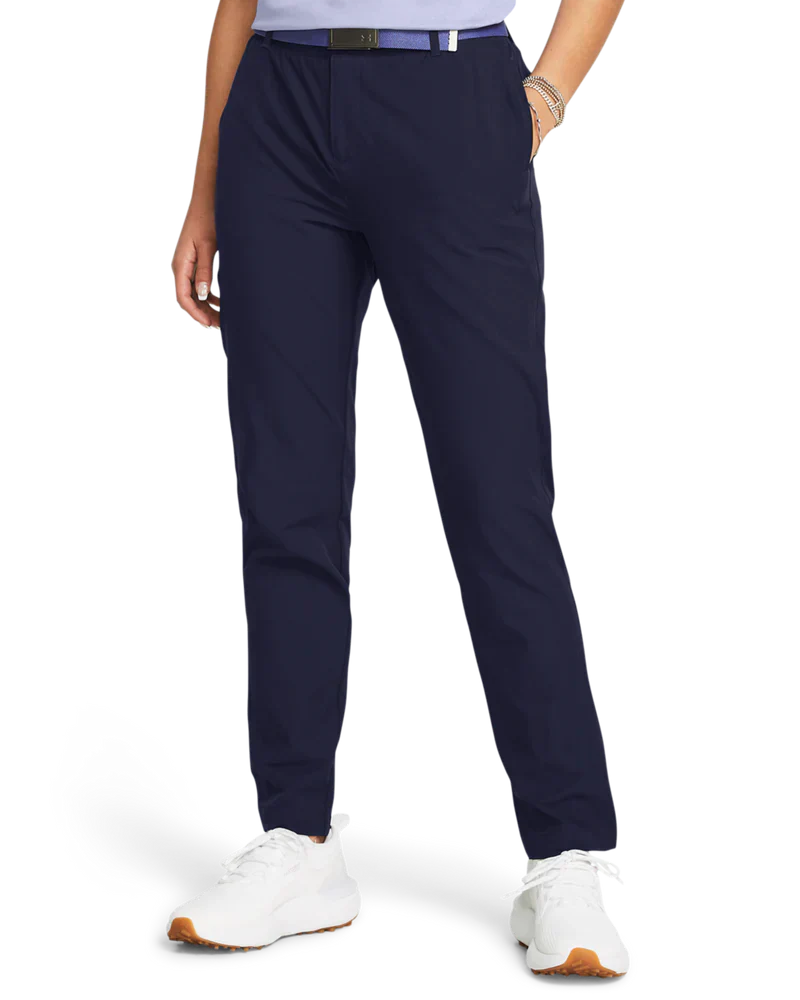 Navy blue golf pants with white sneakers and a belt.