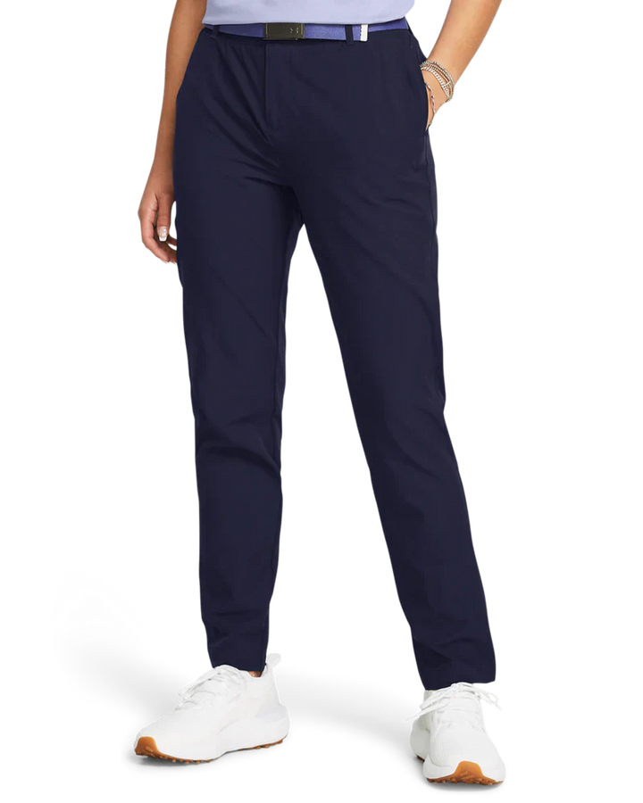Navy blue golf pants with white sneakers and a belt.